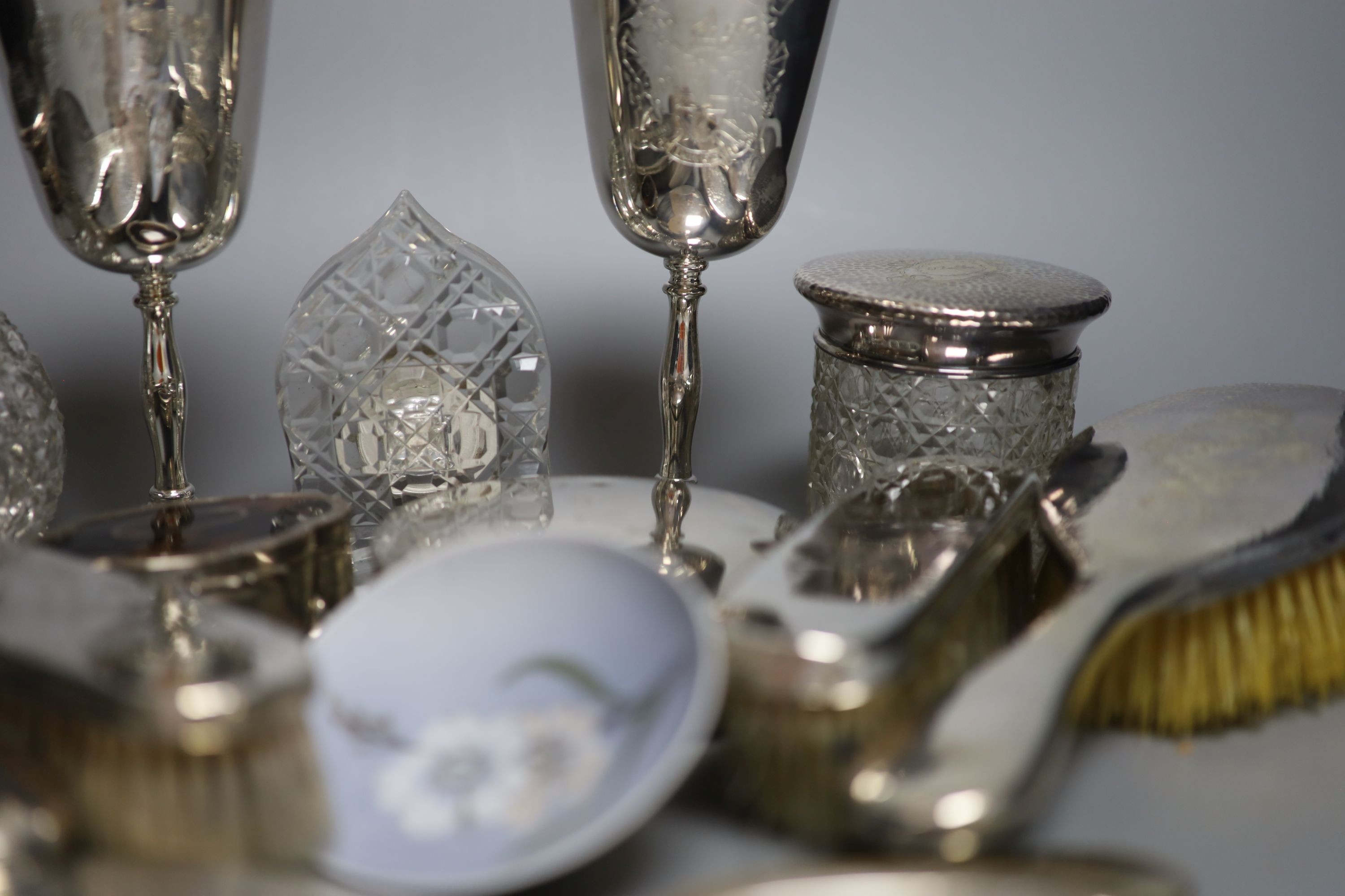 A George V hammered silver ten piece dressing table set with tray, engraved 'Stella' and six other items including a silver circular powder box?, a tortoiseshell mounted trinket box and two plate goblets.